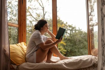 full-shot-woman-reading-bed-red